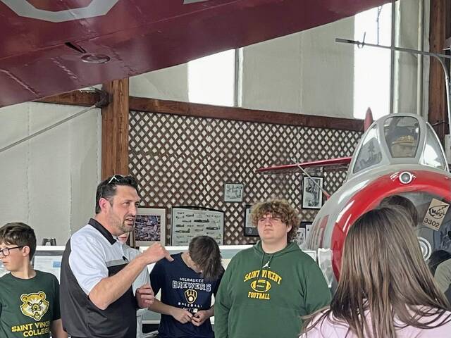 Greater Latrobe Junior High science teacher AJ Haberkorn, second left, leads students in his Flight and Space course on a May 2024 field trip to the KLBE Air Museum at Arnold Palmer Regional Airport in Unity.