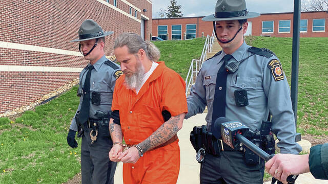 Kenneth Crider, 44, of Maryland, is led into the state police barracks in Hempfield on April 8 after being extradited from North Carolina.